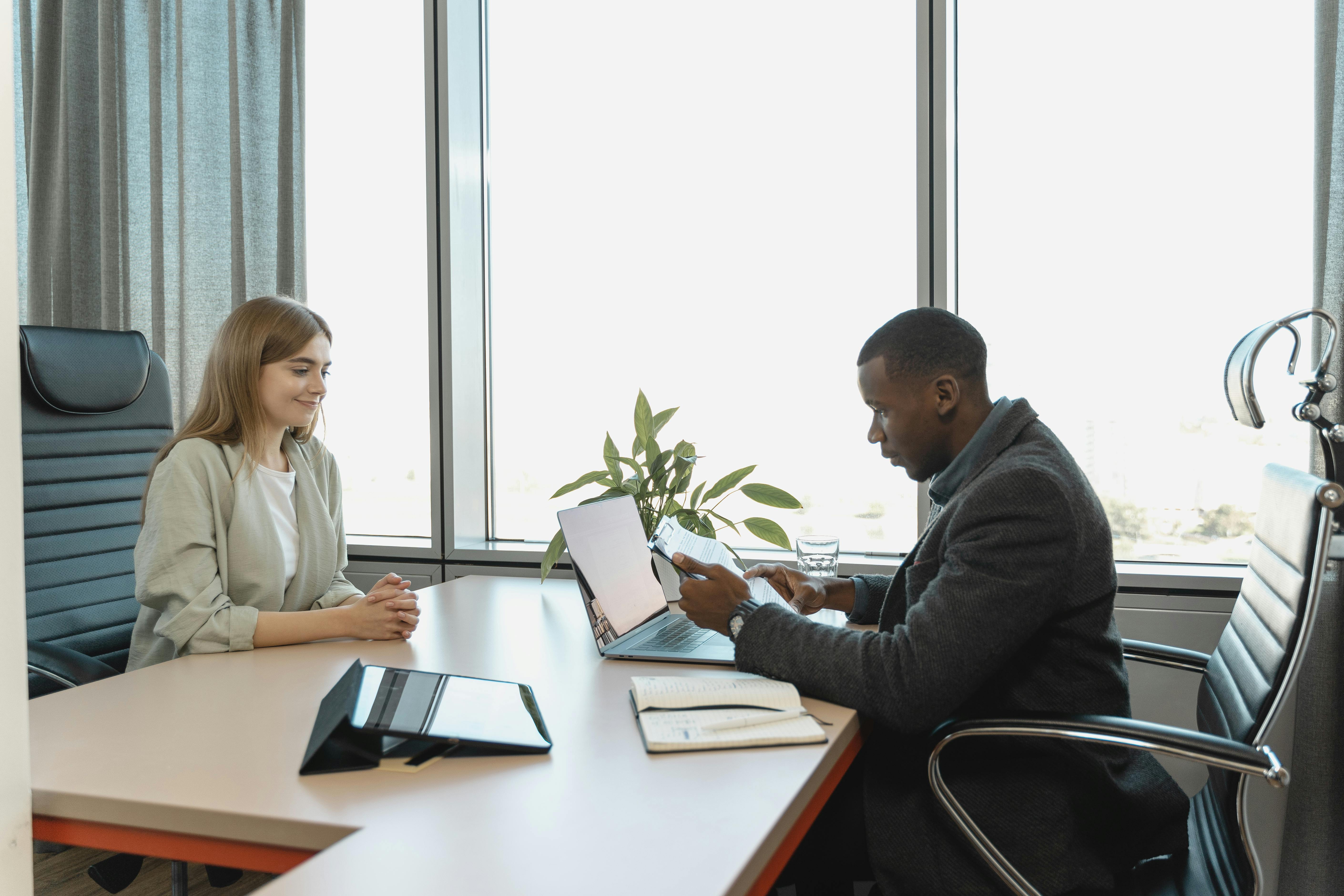 Two people sitting across from eachother at a desk